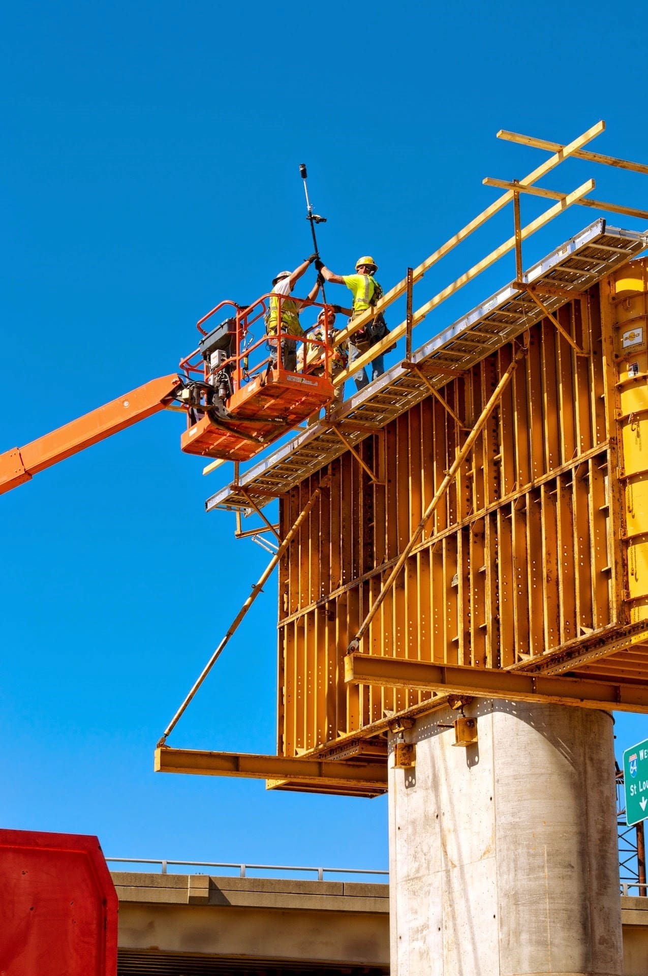 Survey crew on a lift for roadway construction project